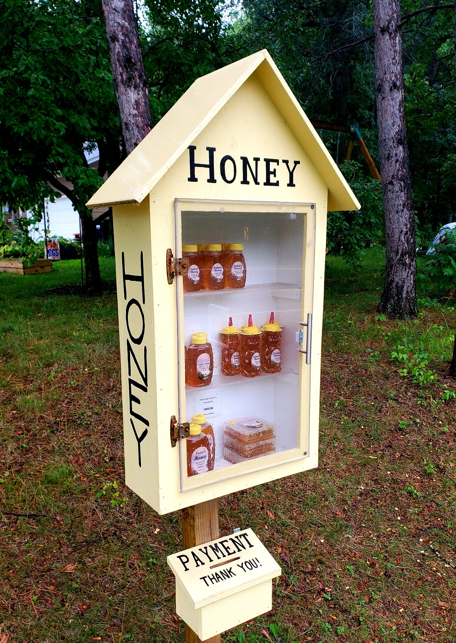 The yellow Sunrise Honey roadside honor stand